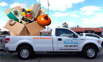 A white truck with junk removal in the back of it.