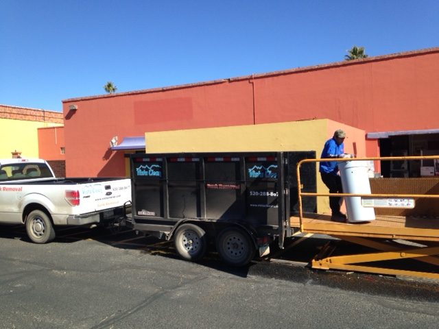A man standing on the back of a trailer.