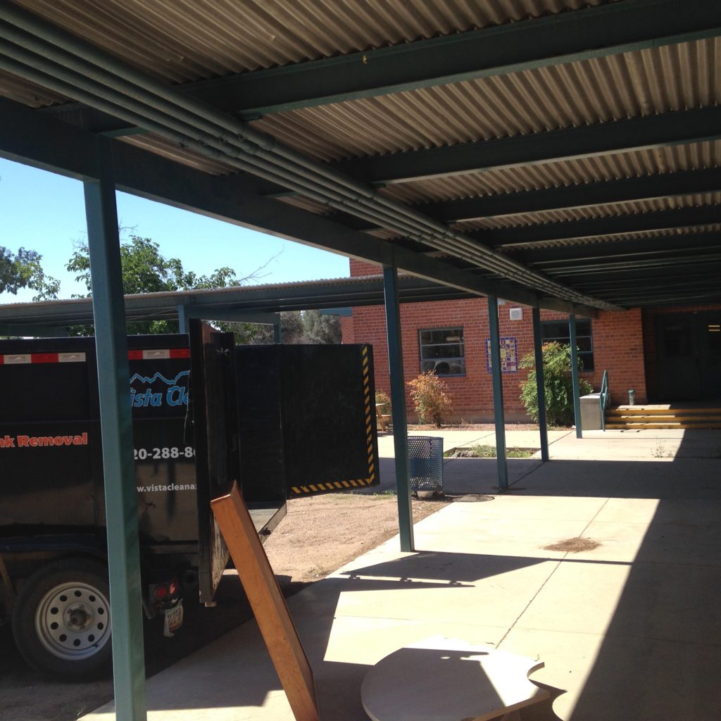 A truck parked under a metal structure.