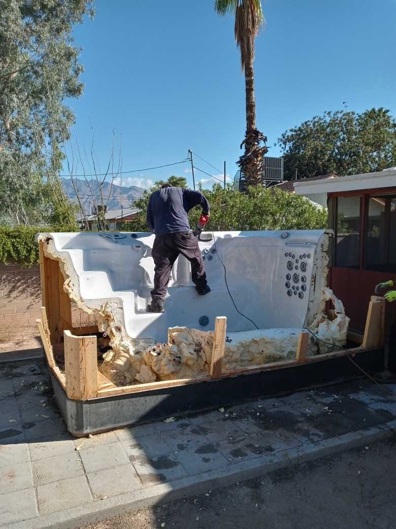 A Before Photo of a worker cutting a hot tub down for junk removal in Flowing Wells, AZ