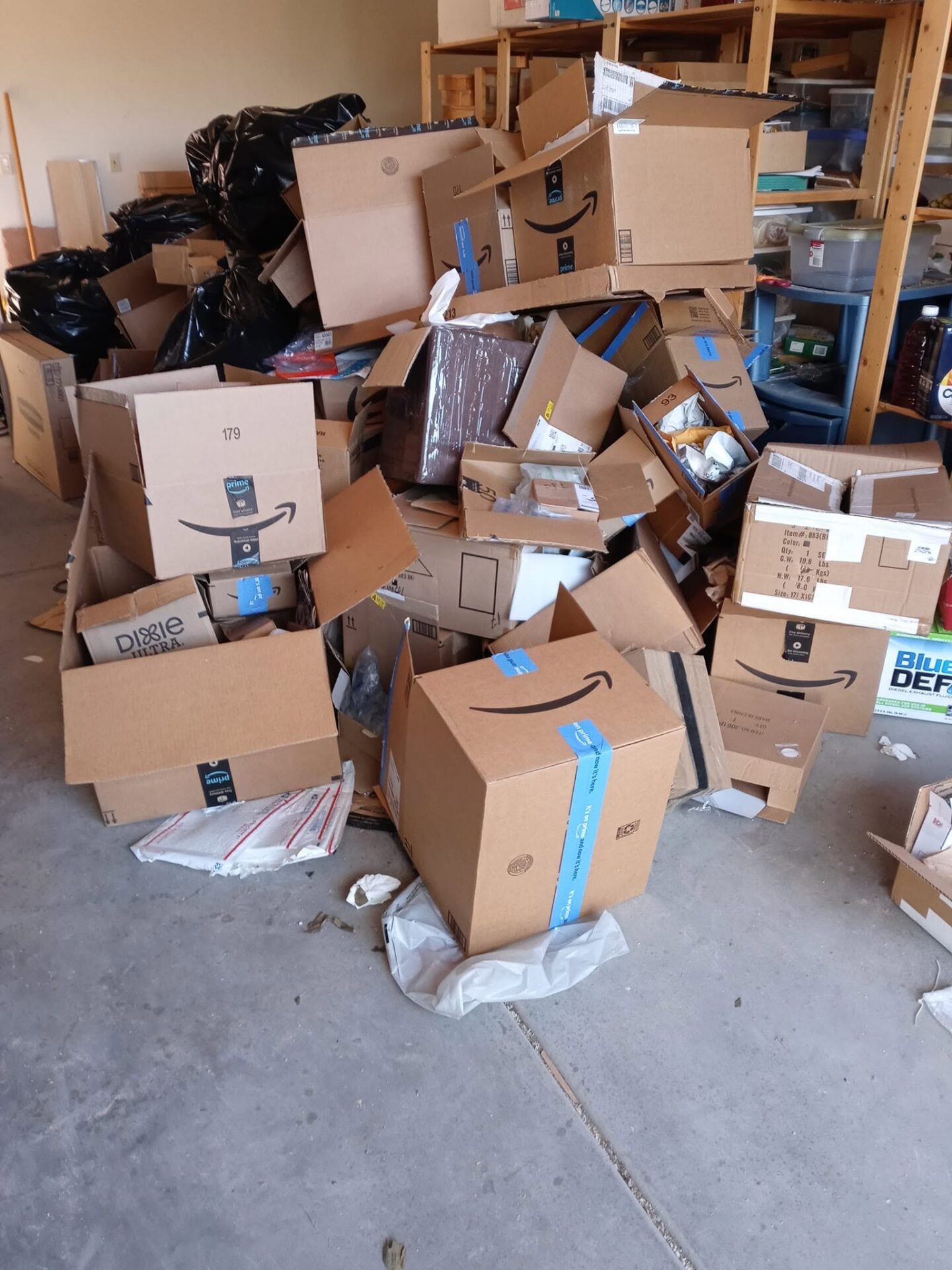Before photo of a garage packed with boxes and debris before junk removal in Marana, AZ