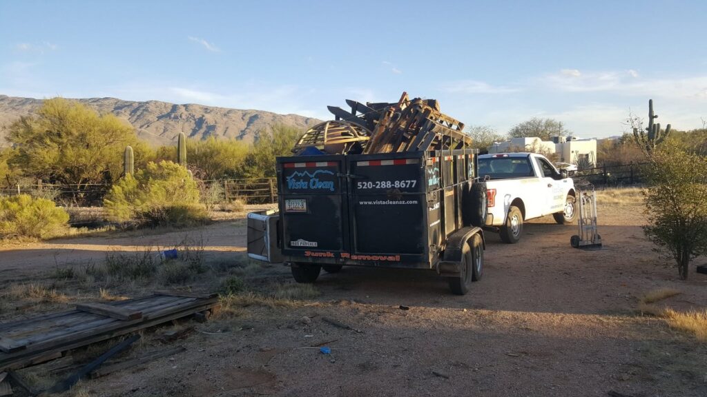 Photo of a Vista Clean Junk Removal Truck and trailer loaded with pallets and debris